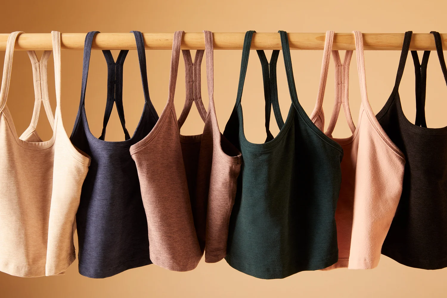Beyond Yoga tanks on a rail