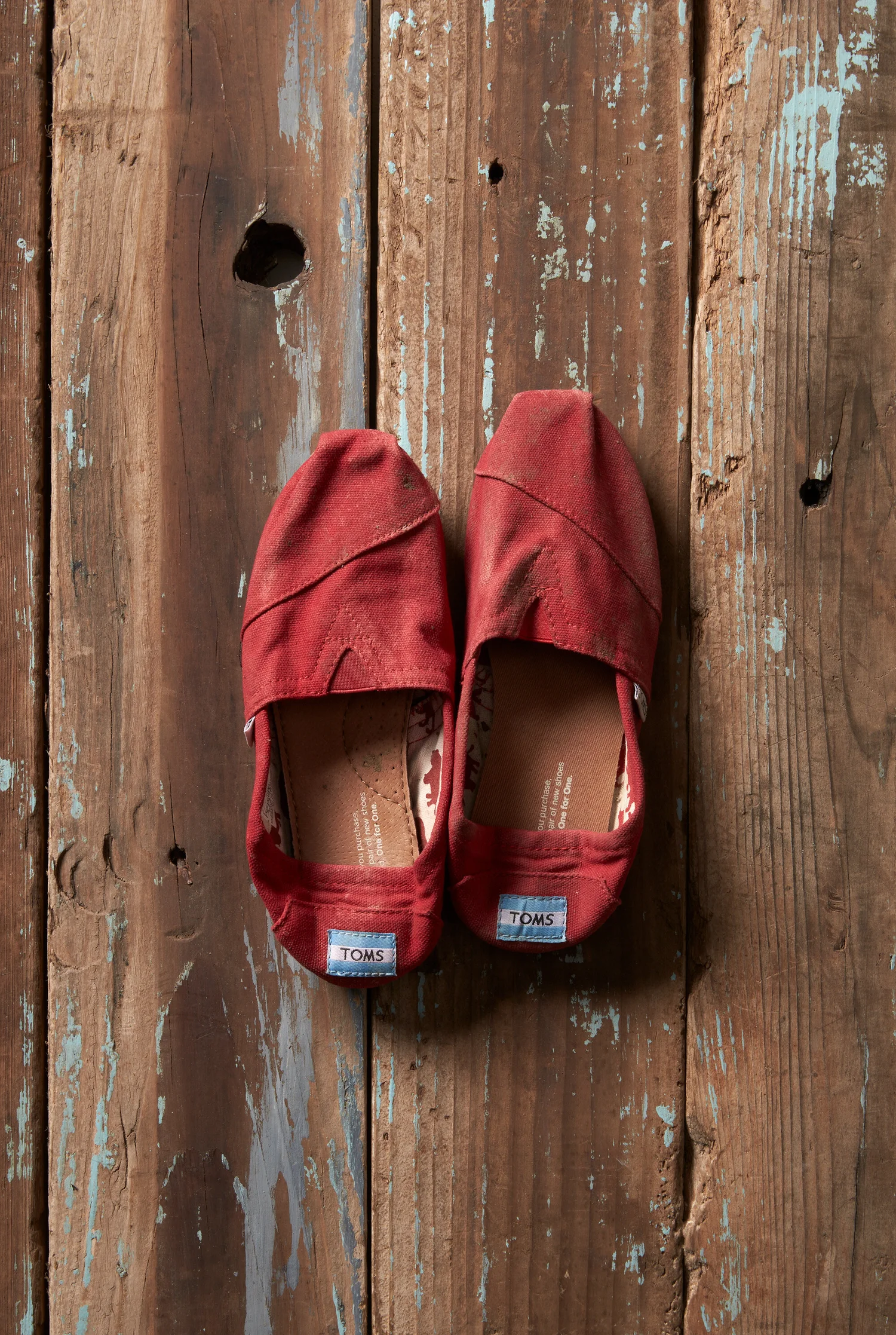 Red TOMS classics on wood
