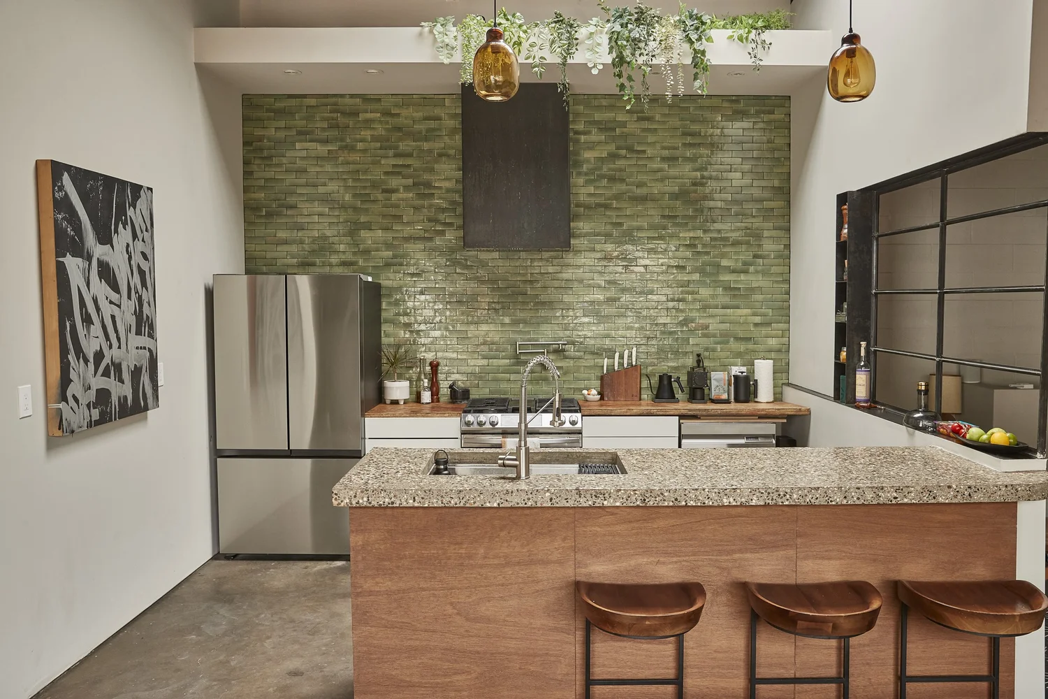 Studio kitchen with green brick backsplash